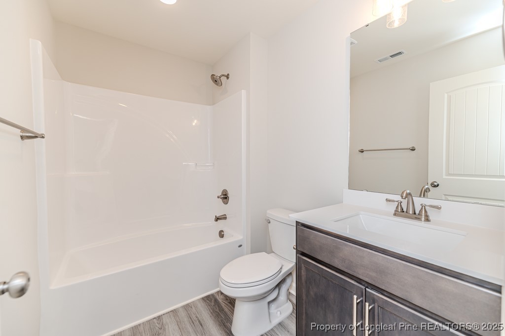 87 Onslow Court Spring Lake, NC 28390 - Photo 26 of 32 a bathroom with a sink toilet and shower