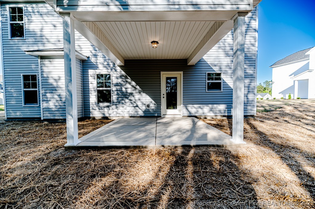 87 Onslow Court Spring Lake, NC 28390 - Photo 29 of 32 a view of a patio with table and chairs with wooden floor and fence