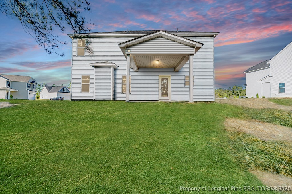 87 Onslow Court Spring Lake, NC 28390 - Photo 31 of 32 a front view of a house with a yard and garage