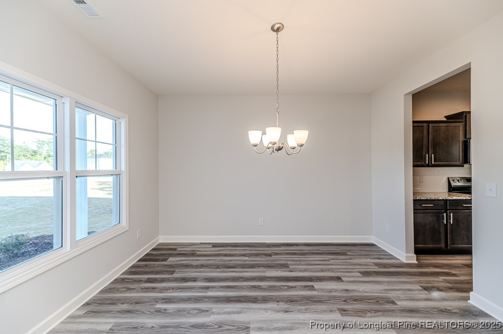 87 Onslow Court Spring Lake, NC 28390 - Photo 4 of 32 a view of empty room with wooden floor and fan