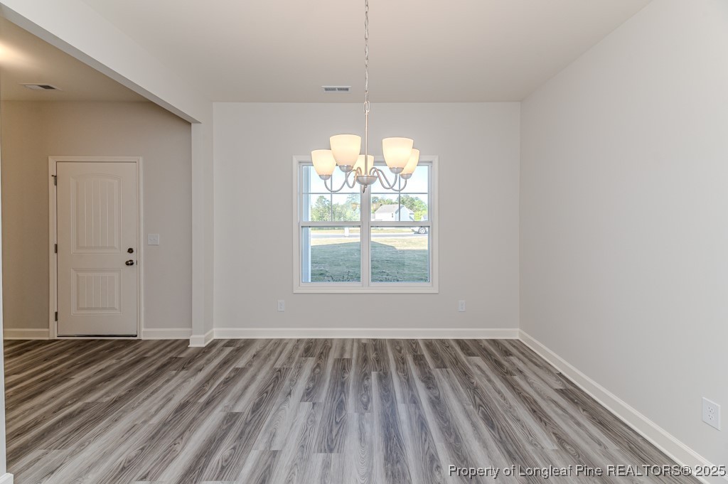 87 Onslow Court Spring Lake, NC 28390 - Photo 5 of 32 wooden floor in an empty room with a window