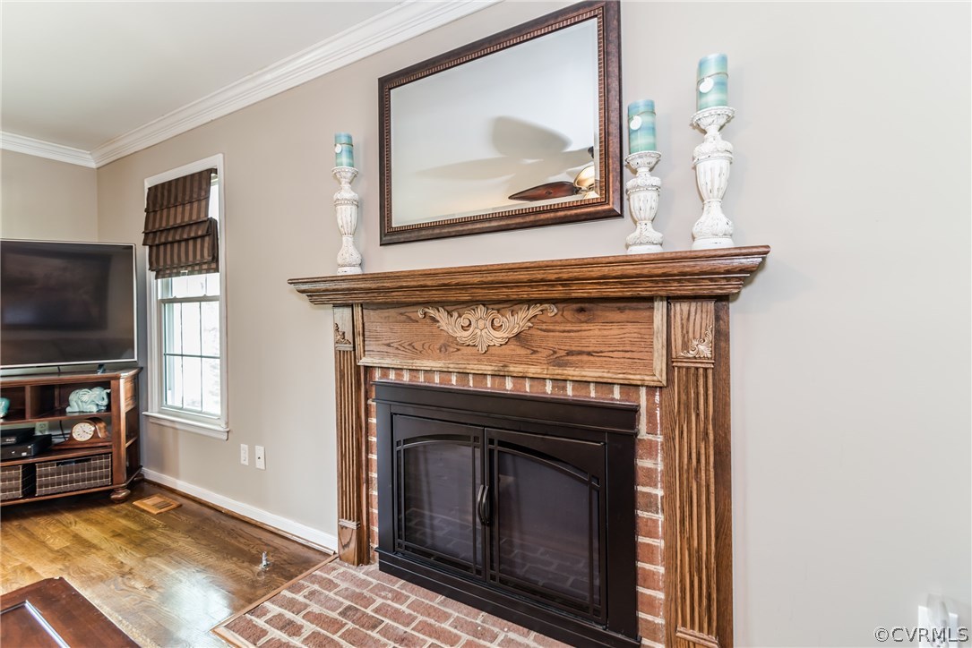 4824 Cedar Cliff Road Chester, VA 23831 - Photo 12 of 50 a living room with a fireplace a flat screen tv and a window