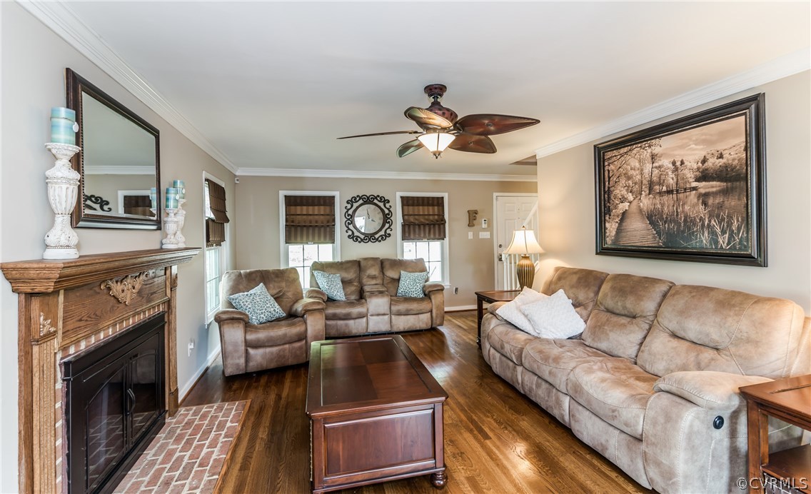 4824 Cedar Cliff Road Chester, VA 23831 - Photo 16 of 50 a living room with furniture a fireplace and a flat screen tv