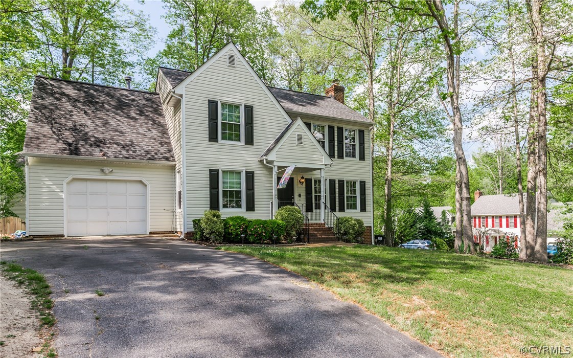 4824 Cedar Cliff Road Chester, VA 23831 - Photo 2 of 50 a front view of a house with a garden and plants