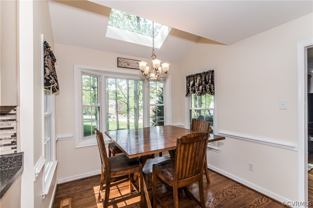 4824 Cedar Cliff Road Chester, VA 23831 - Photo 23 of 50 a dining room with furniture a chandelier and wooden floor