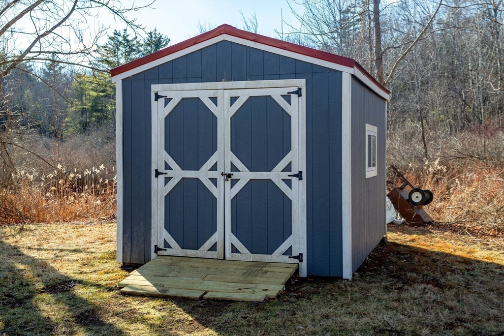 118 Spring Hill Road Ashby, MA 01431 - Photo 28 of 37 a view of a small house with backyard