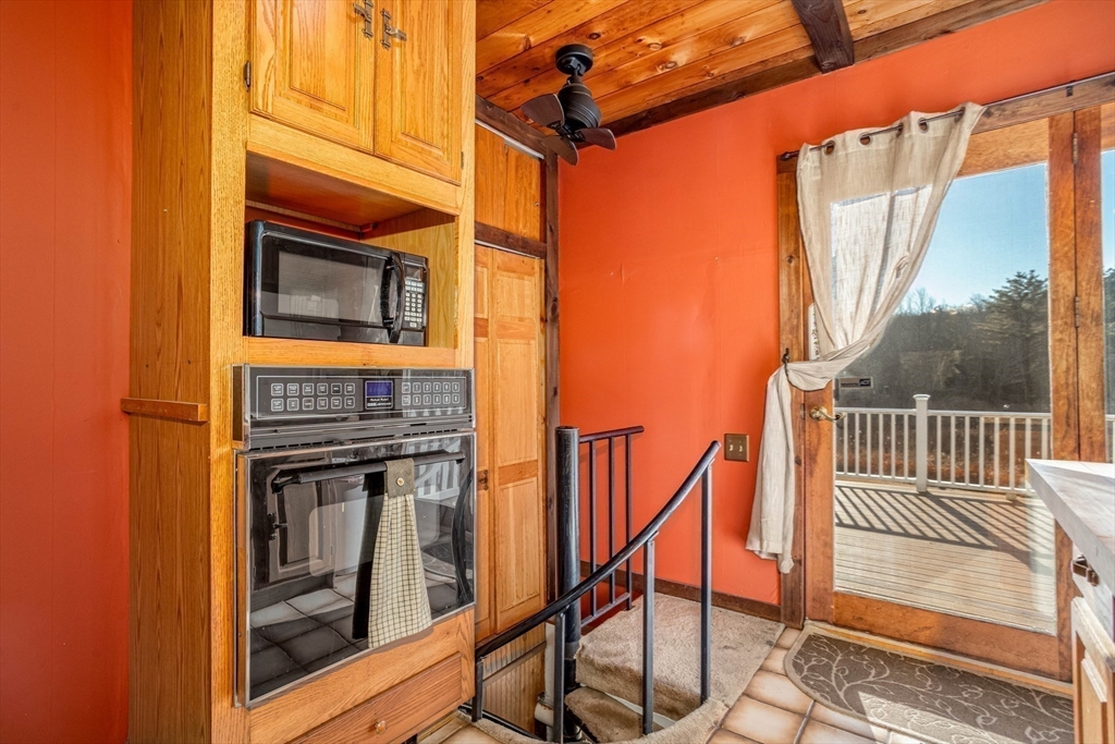 118 Spring Hill Road Ashby, MA 01431 - Photo 8 of 37 a view of a balcony with furniture and floor to ceiling window