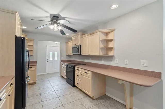 a kitchen with a stove a sink and a refrigerator