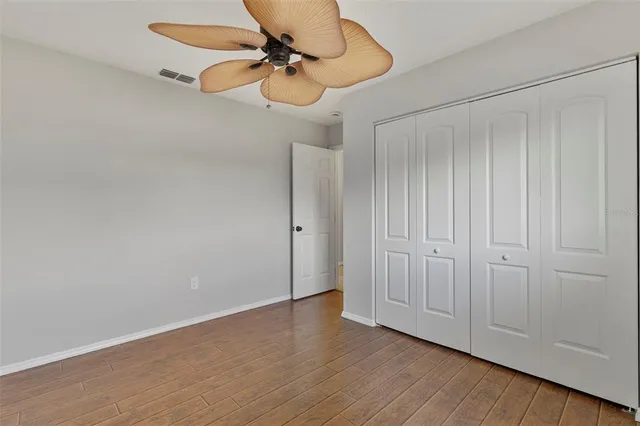 a view of a room with wooden floor and fan