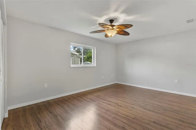 a view of a room with wooden floor and window
