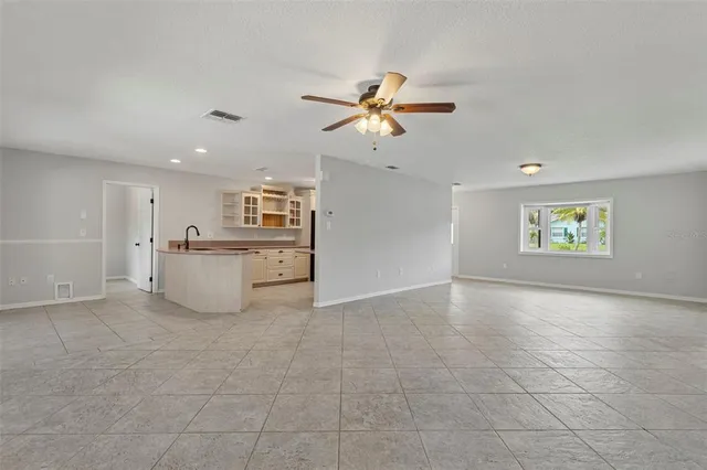 a view of a kitchen with a sink and a refrigerator