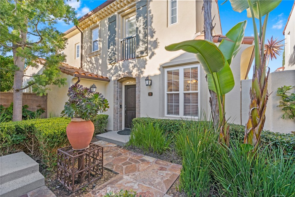 55 Bower Tree Irvine, CA 92603 - Photo 1 of 32 a view of a chair and table in the patio in front of a house
