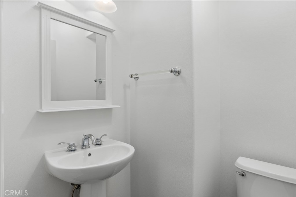 55 Bower Tree Irvine, CA 92603 - Photo 12 of 32 a bathroom with a sink a toilet and a mirror