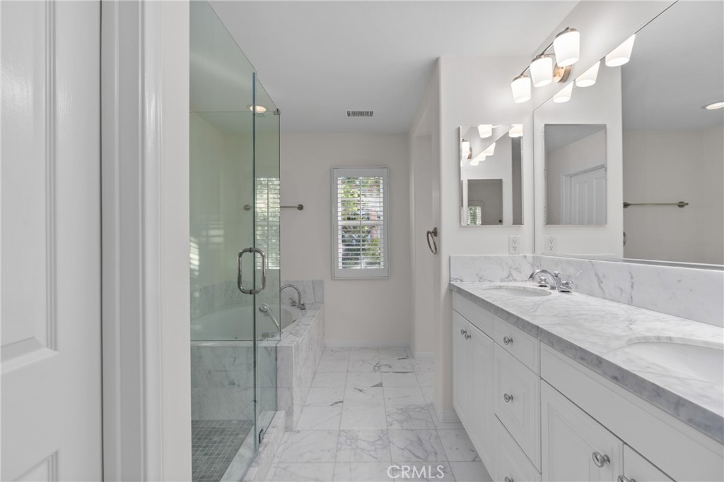 55 Bower Tree Irvine, CA 92603 - Photo 16 of 32 a bathroom with a double vanity sink mirror and shower