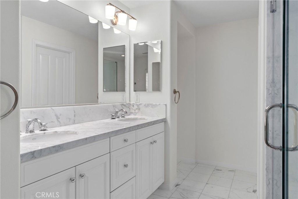 55 Bower Tree Irvine, CA 92603 - Photo 17 of 32 a bathroom with a granite countertop sink and a mirror