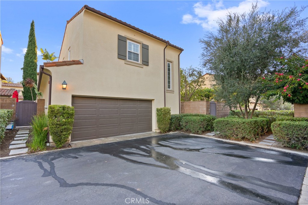 55 Bower Tree Irvine, CA 92603 - Photo 23 of 32 a front view of a house with a yard and garage