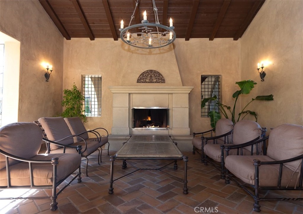 55 Bower Tree Irvine, CA 92603 - Photo 29 of 32 a living room with furniture a chandelier and a fireplace