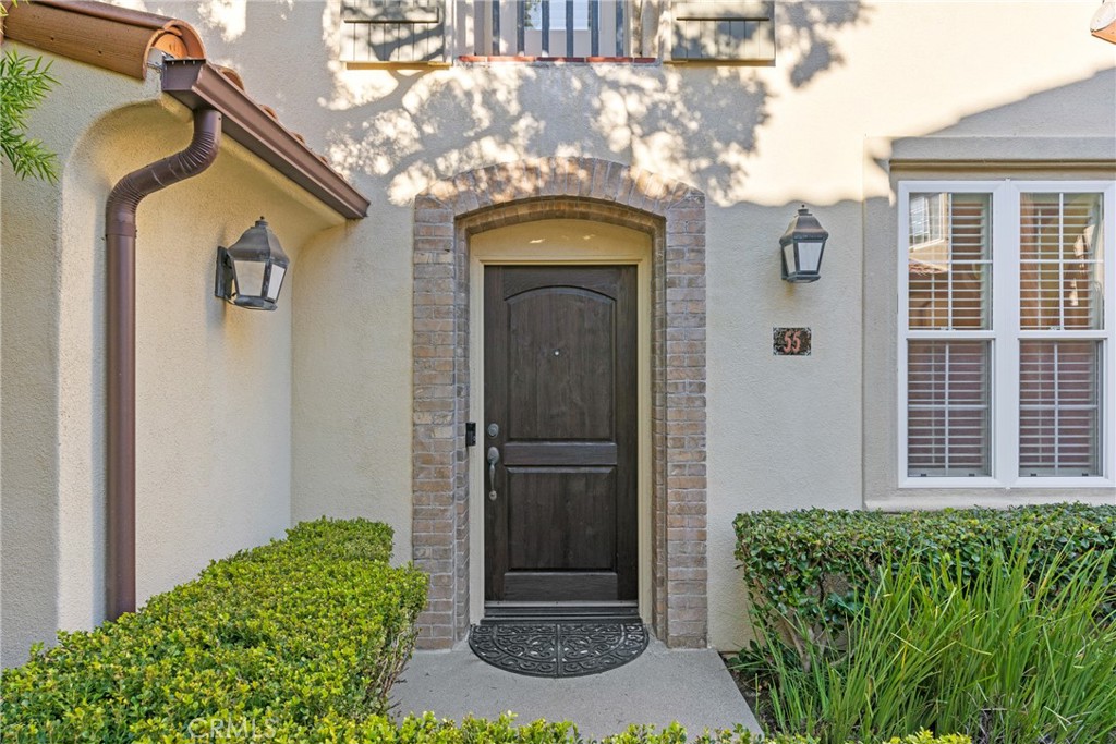55 Bower Tree Irvine, CA 92603 - Photo 3 of 32 a front view of a house with garden