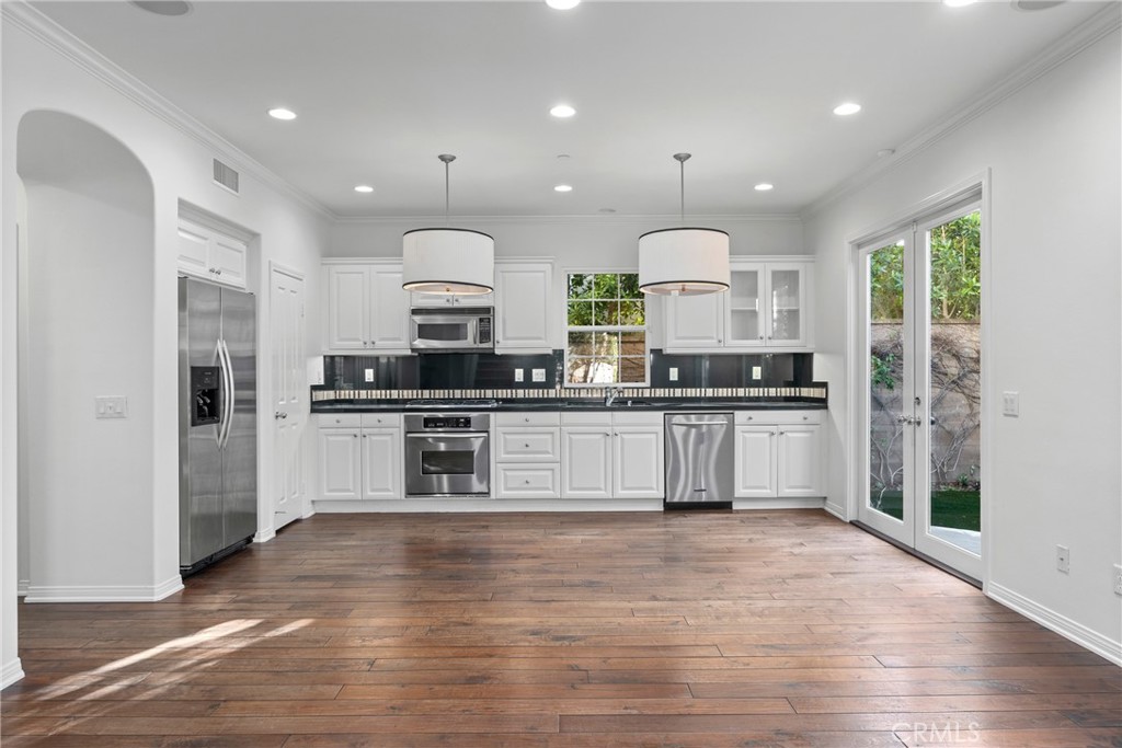 55 Bower Tree Irvine, CA 92603 - Photo 4 of 32 a large kitchen with stainless steel appliances kitchen island granite countertop a stove a sink and a refrigerator