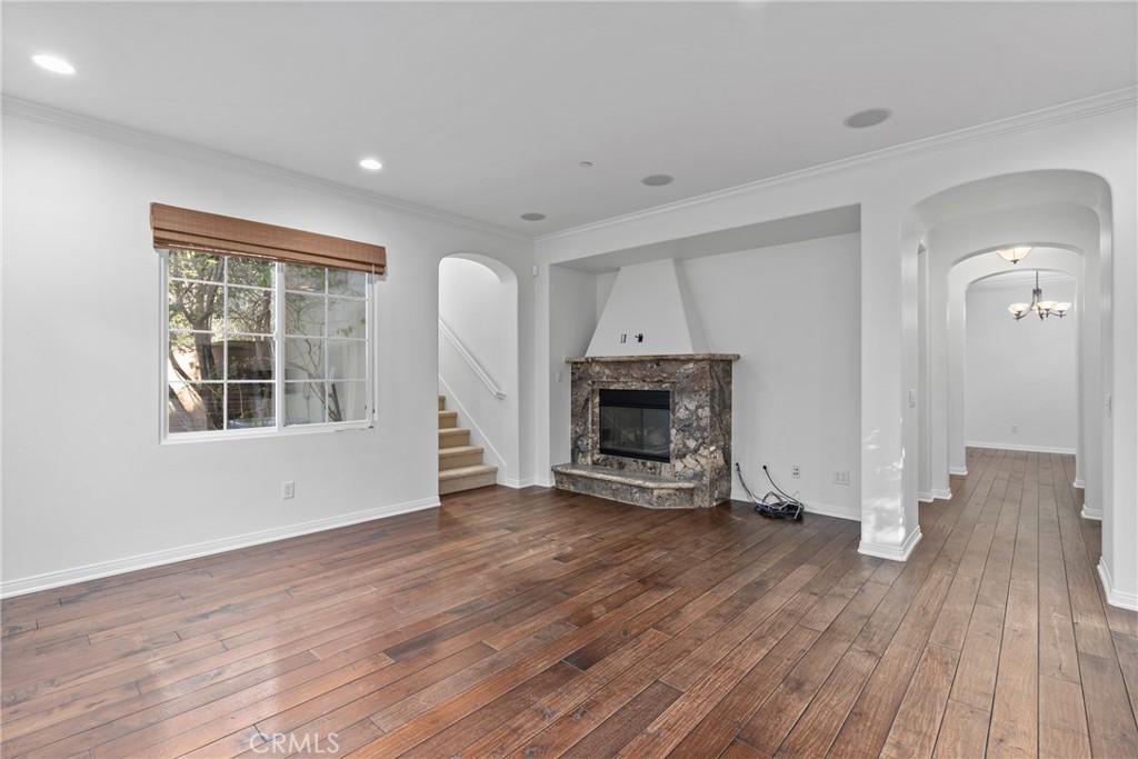 55 Bower Tree Irvine, CA 92603 - Photo 9 of 32 a view of empty room with wooden floor and fireplace
