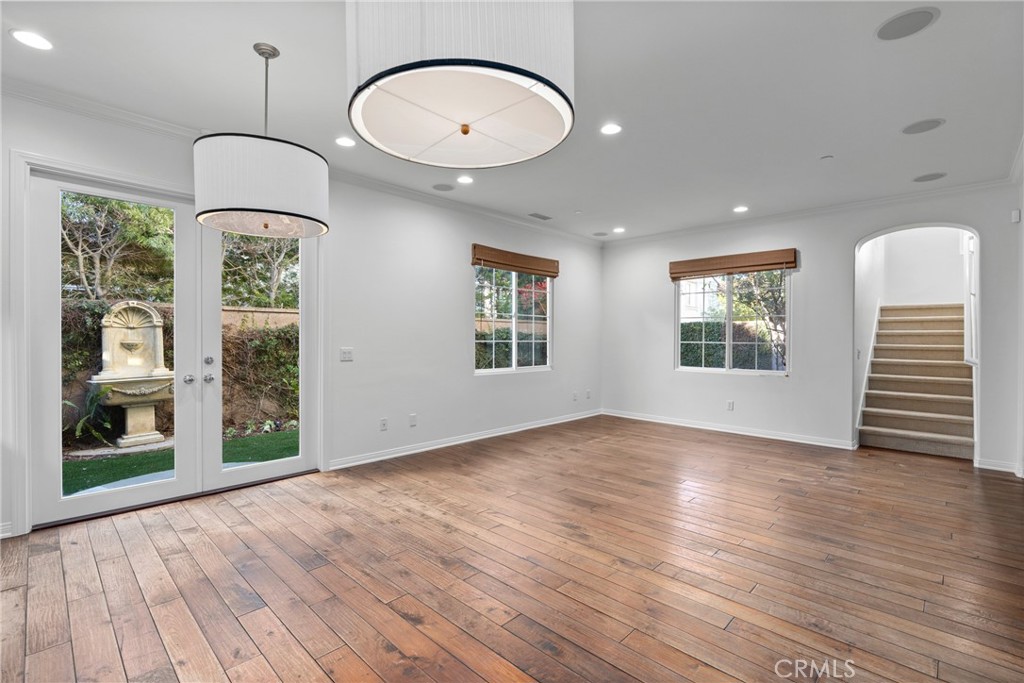 55 Bower Tree Irvine, CA 92603 - Photo 10 of 32 an empty room with wooden floor windows and entrance