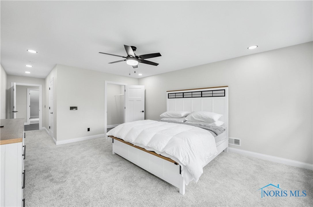9414 Sheffield Road Perrysburg, OH 43551 - Photo 27 of 34 The upstairs guest room has ample space, ceiling fan, luxury carpeting, two closets and an ensuite bathroom.