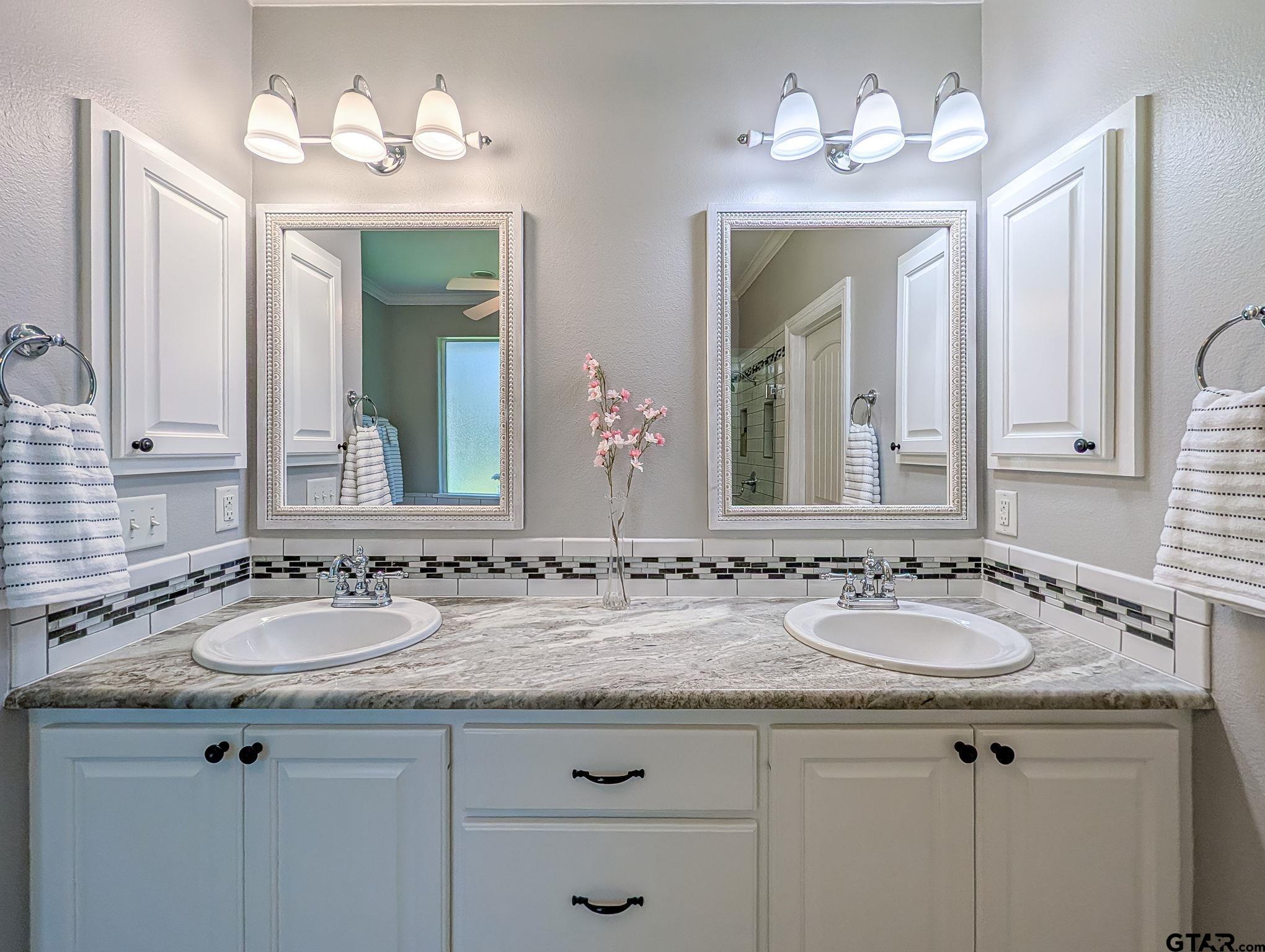 18488 Bluebird Circle Flint, TX 75762 - Photo 25 of 47 a bathroom with a granite countertop sink and a large mirror