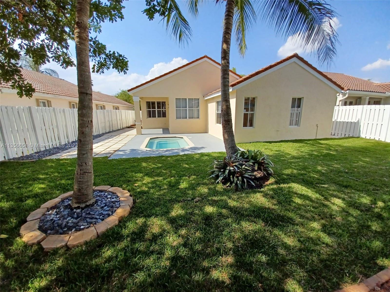 680 Falling Water Road Weston, FL 33326 - Photo 2 of 37 a house view with a garden space