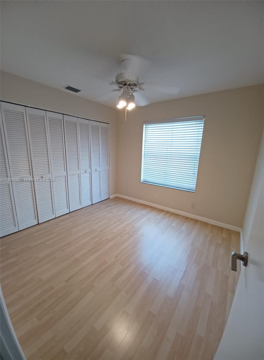 680 Falling Water Road Weston, FL 33326 - Photo 24 of 37 wooden floor in an empty room with a window