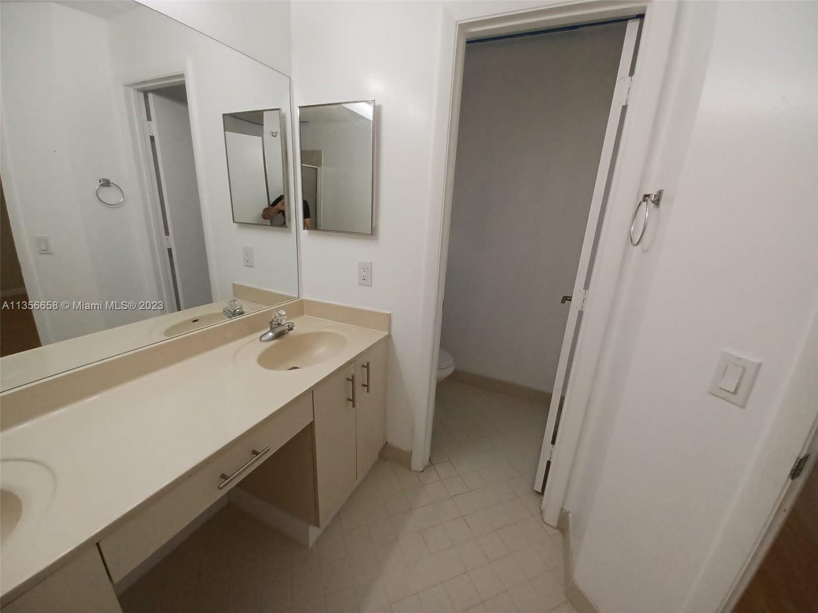 680 Falling Water Road Weston, FL 33326 - Photo 26 of 37 a bathroom with a sink and mirror