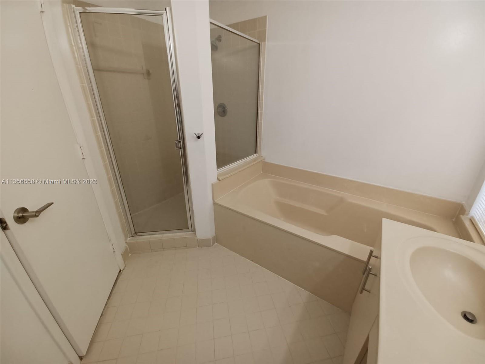 680 Falling Water Road Weston, FL 33326 - Photo 27 of 37 a bathroom with a tub and sink