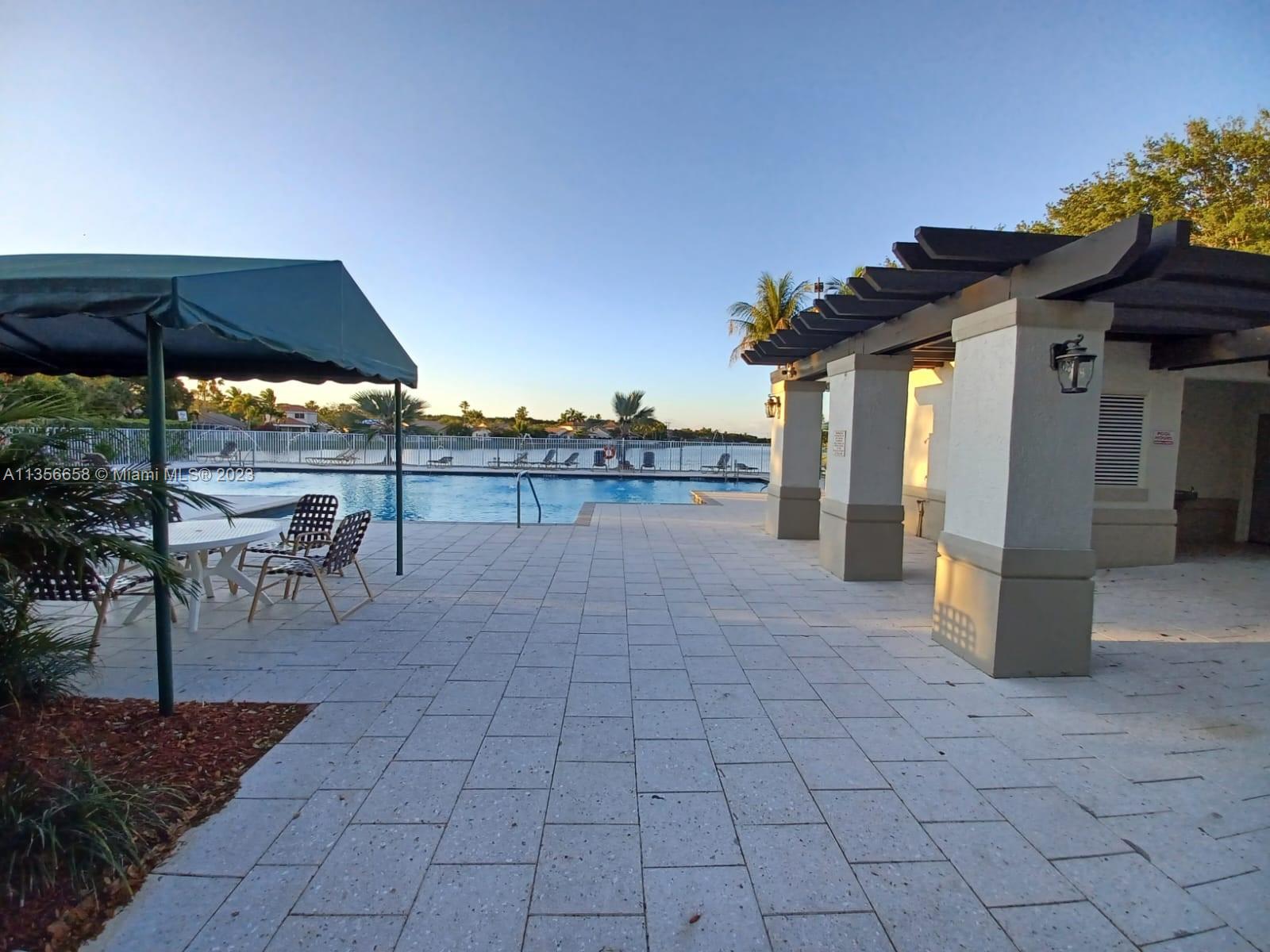 680 Falling Water Road Weston, FL 33326 - Photo 30 of 37 a view of a terrace with sitting area