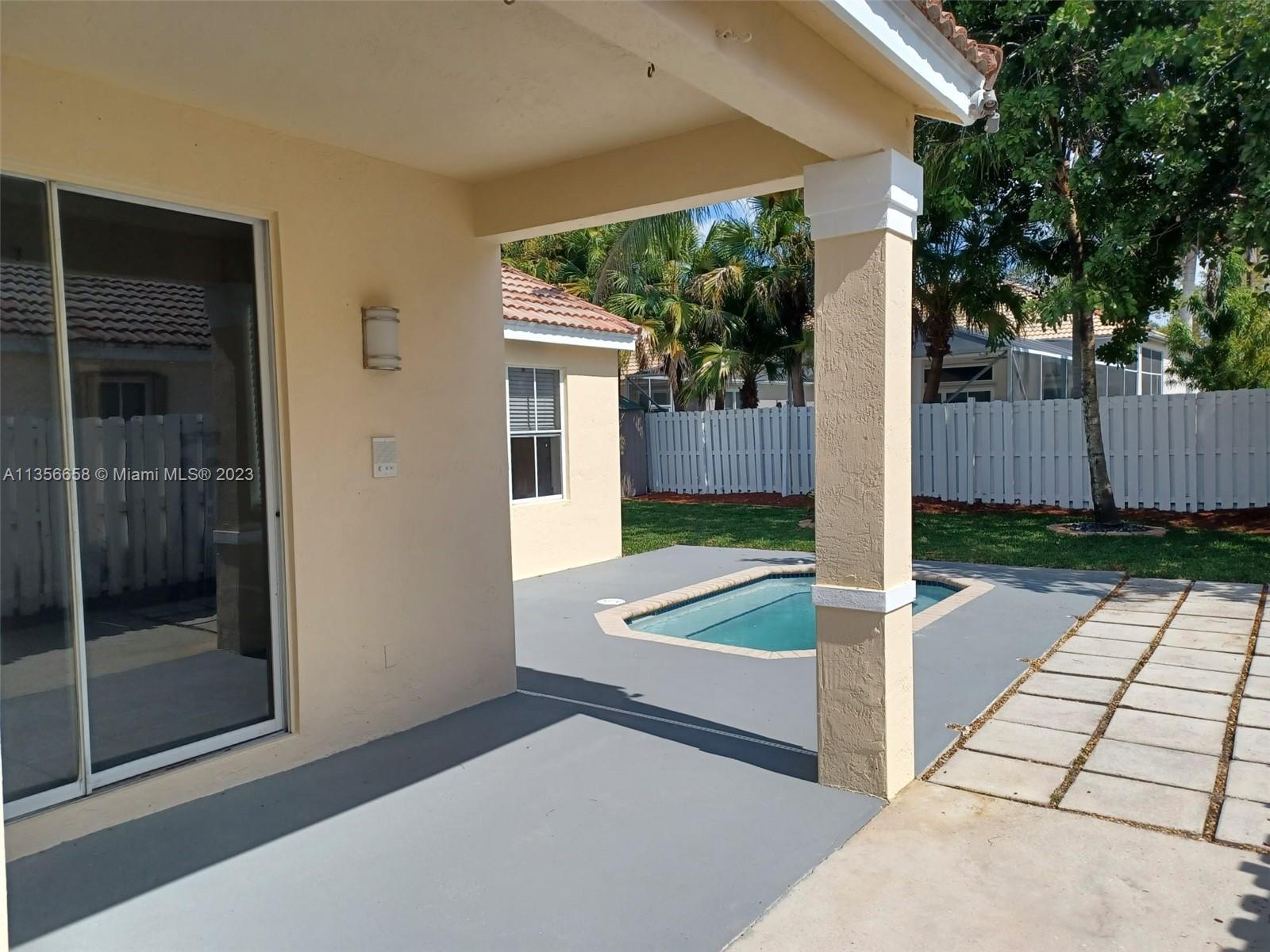 680 Falling Water Road Weston, FL 33326 - Photo 8 of 37 a view of a backyard with a garden and plants