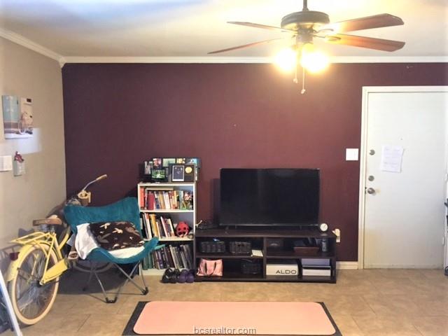 4400 Boyett Street, Unit B Bryan, TX 77801 - Photo 2 of 11 a living room with furniture and a flat screen tv