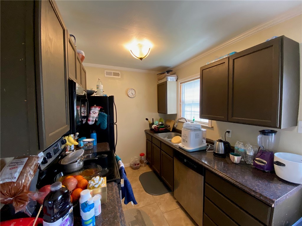 4400 Boyett Street, Unit B Bryan, TX 77801 - Photo 3 of 11 a kitchen with a sink appliances and cabinets
