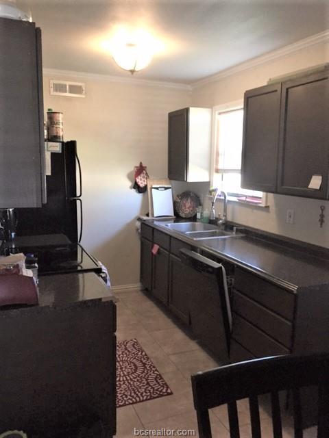 4400 Boyett Street, Unit B Bryan, TX 77801 - Photo 9 of 11 a kitchen with a sink and cabinets