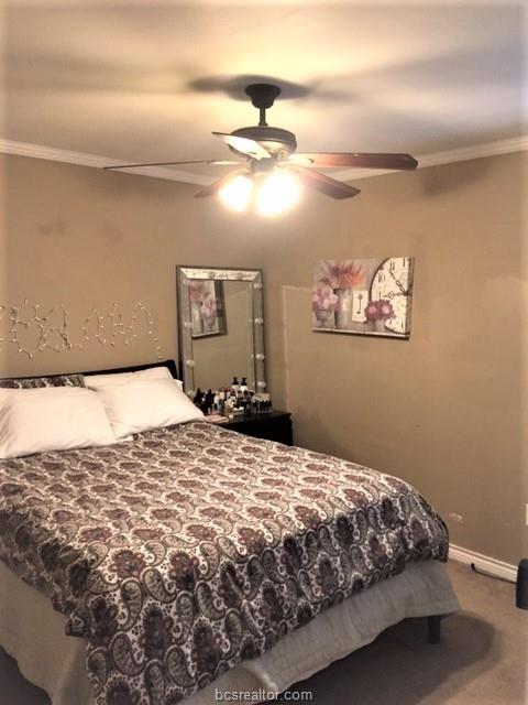 4400 Boyett Street, Unit B Bryan, TX 77801 - Photo 10 of 11 a bedroom with a bed and a chandelier