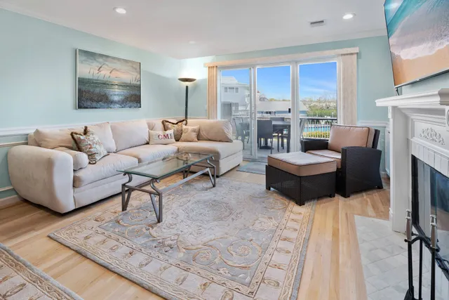 a living room with fireplace furniture and a large window