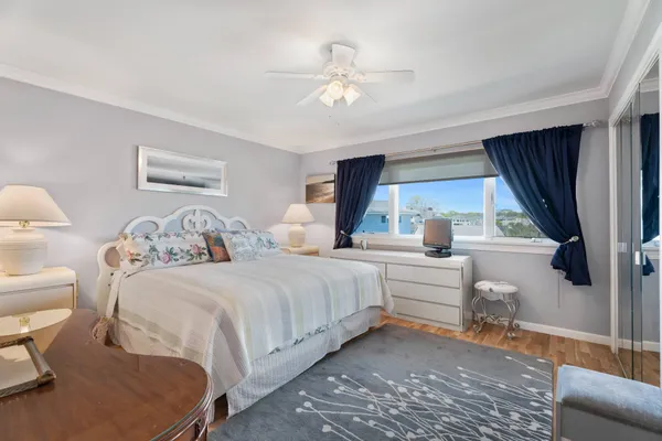 a bedroom with a large bed and a window