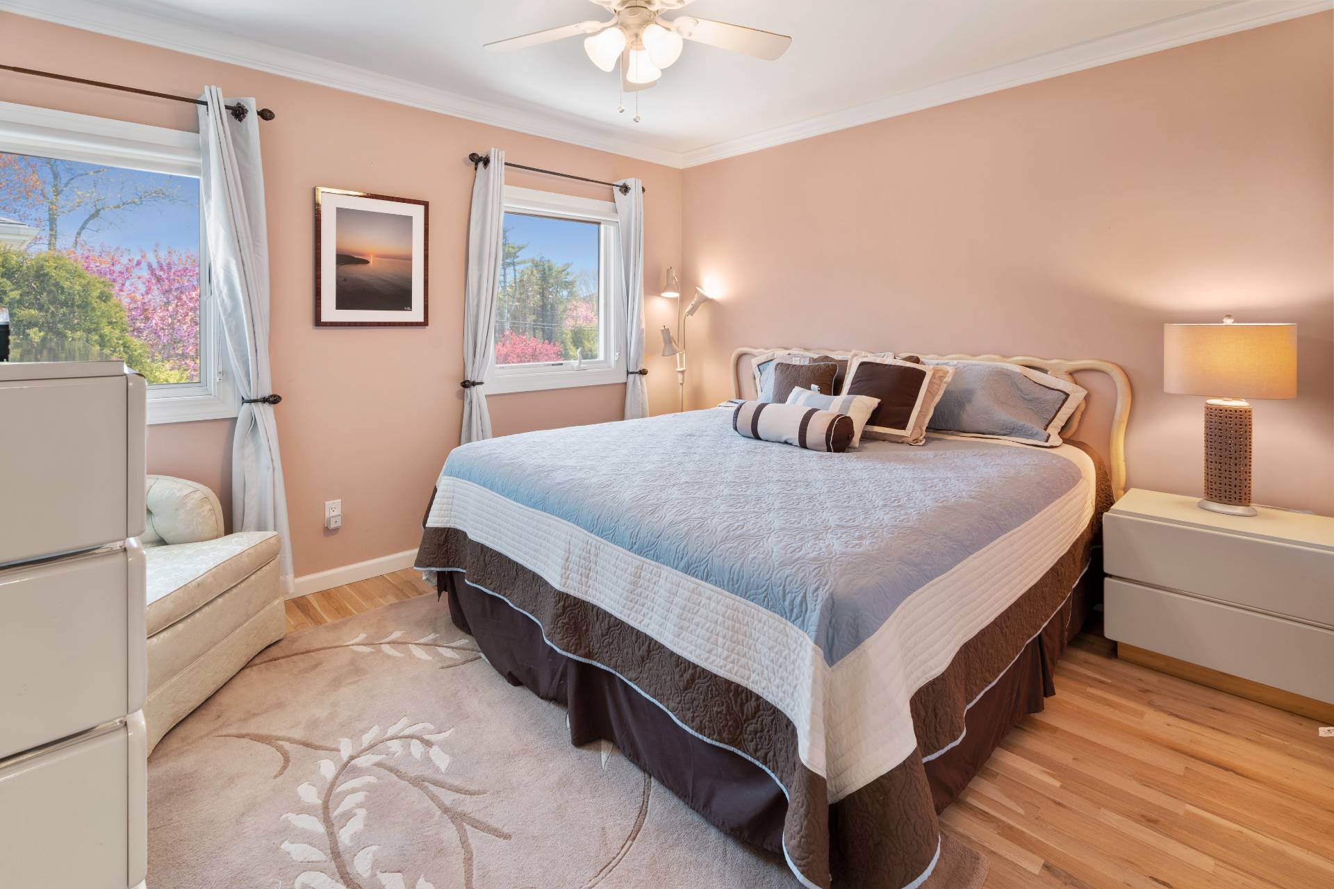 3012 Mitchell Road Westhampton Beach, NY 11978 - Photo 10 of 25 a bedroom with a bed and a chandelier