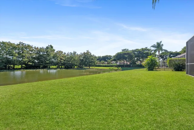 a living room with furniture a flat screen tv and a large window