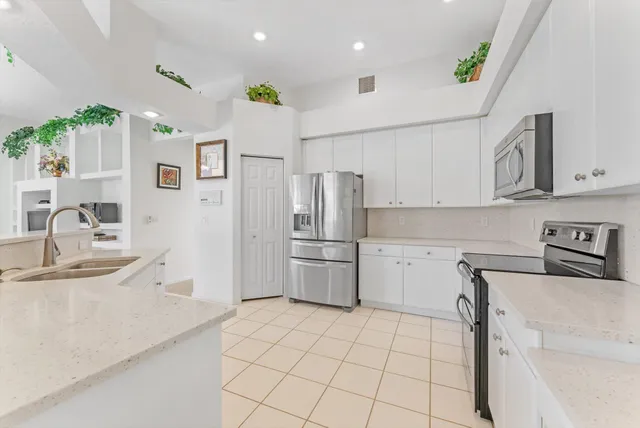 a living room with furniture fireplace and a large window