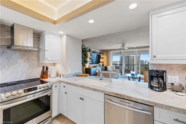 a kitchen with stainless steel appliances granite countertop a stove and a sink