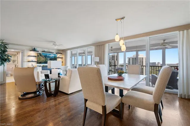 a dining room with furniture window and wooden floor