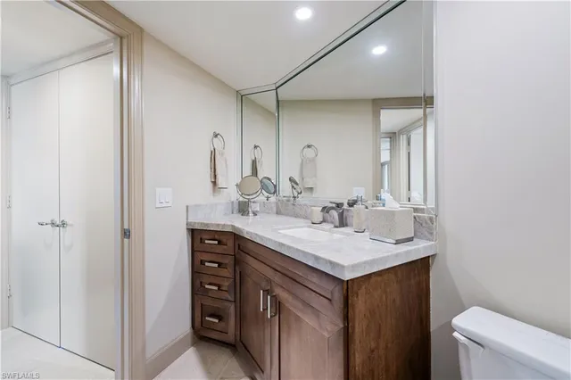 a bathroom with a sink a toilet and a mirror