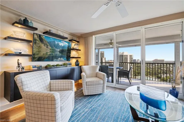 a living room with furniture and a floor to ceiling window