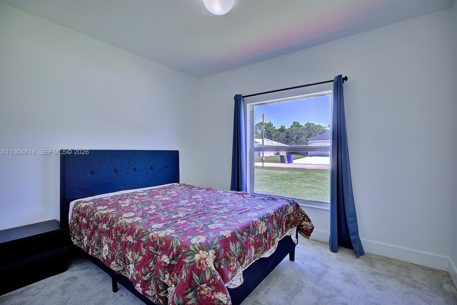 827 Renault Avenue Sebring, FL 33872 - Photo 14 of 27 a bedroom with a large bed and a window