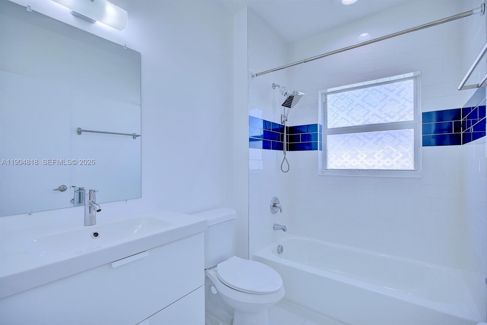 827 Renault Avenue Sebring, FL 33872 - Photo 16 of 27 a bathroom with a bathtub shower sink vanity and toilet