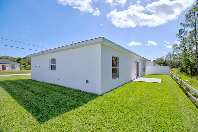 a view of a backyard with plants and a small yard