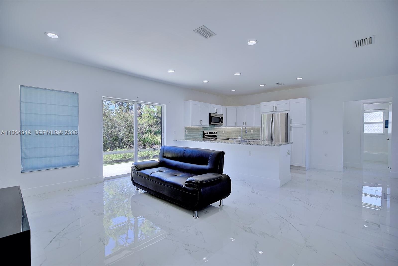 827 Renault Avenue Sebring, FL 33872 - Photo 8 of 27 a living room with furniture and a large window